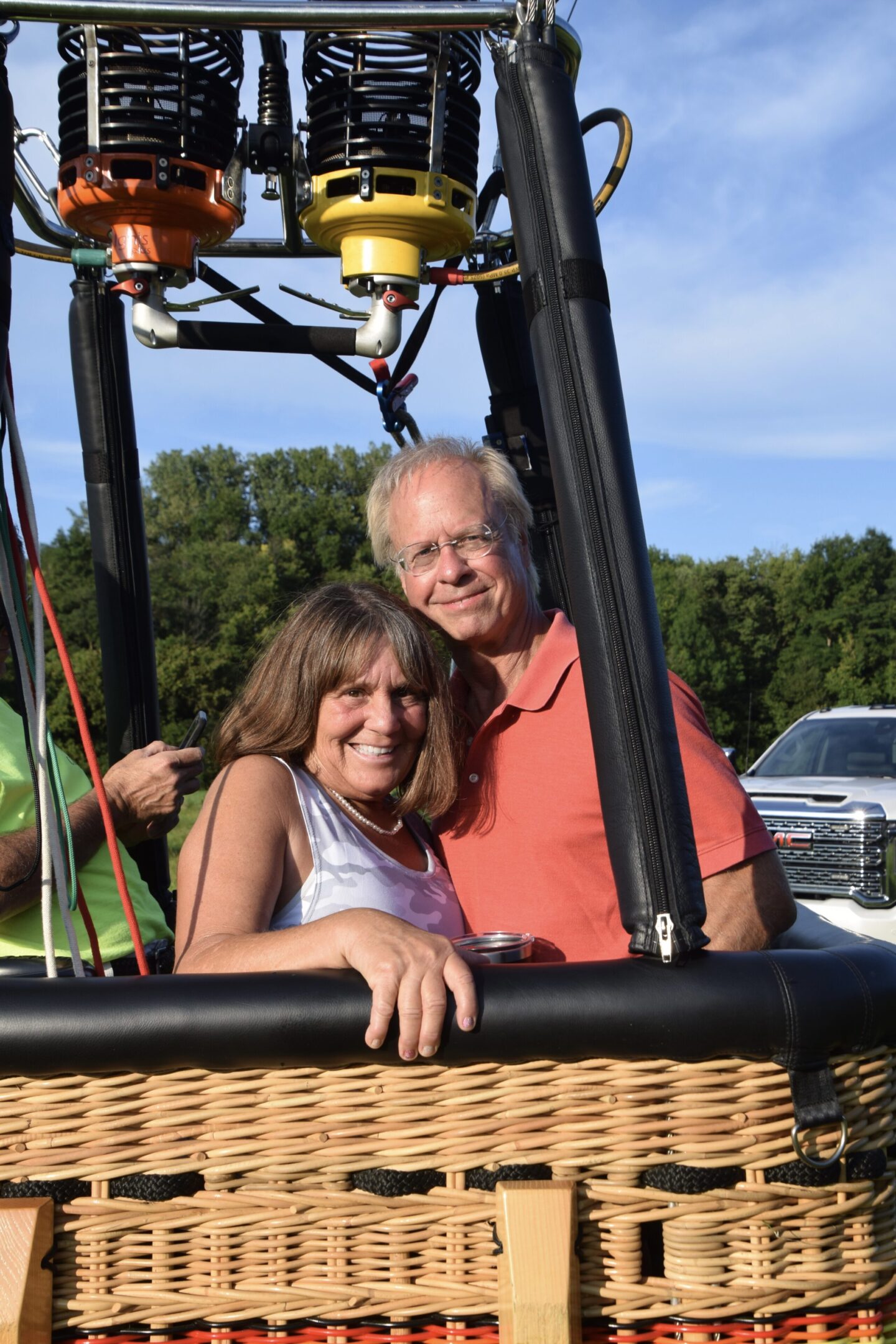 Couple smiling inside hot air balloon basket