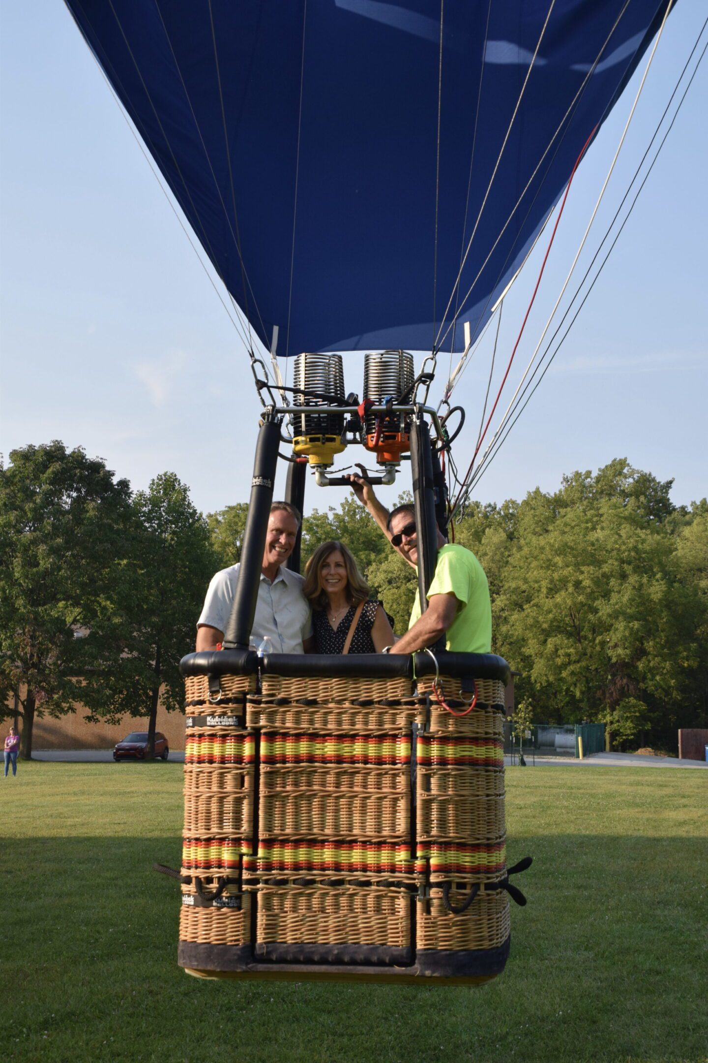 Three people in hot air balloon basket