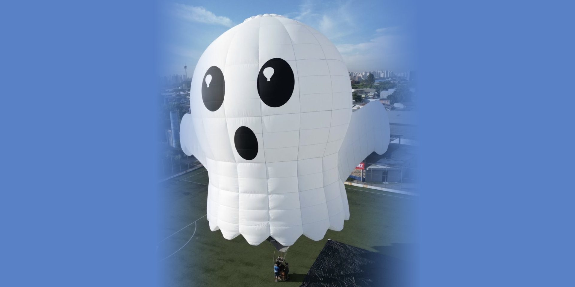 White ghost-shaped hot air balloon over town